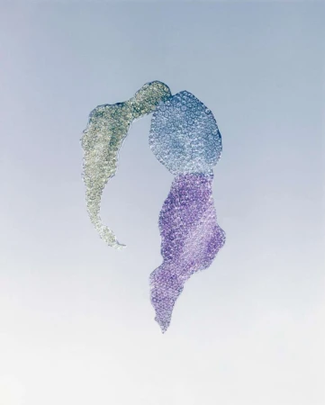Abstract image features swirling purple, blue, and silver textures against a light background, creating a visually fluid design.