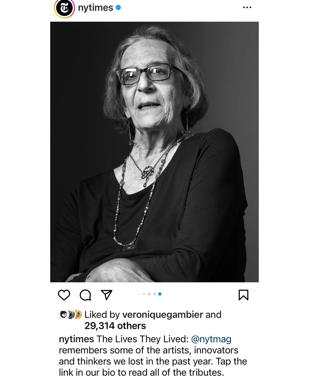 Black and white portrait of an elderly woman wearing glasses and a long necklace by photographer Carlton Davis.