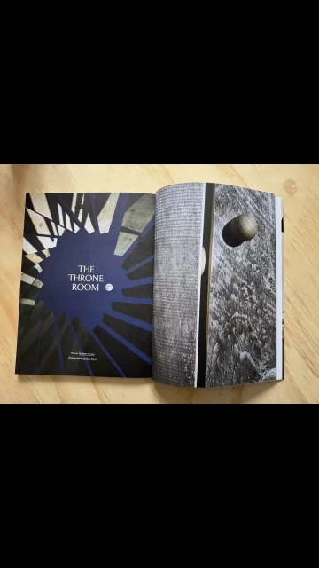 Open book with 'The Throne Room' title and architectural photo of a door, showcasing artistic design and textual elements.