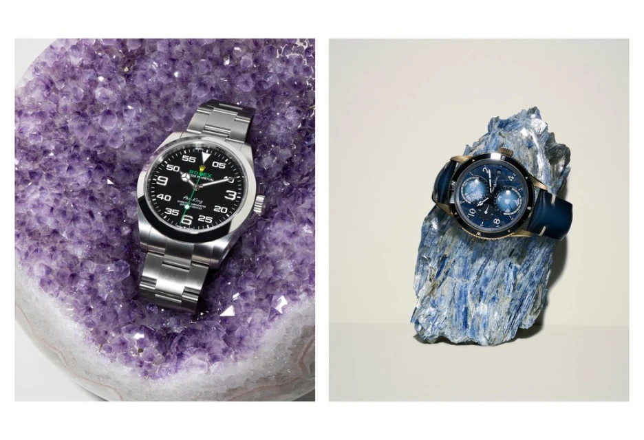 Two luxury wristwatches displayed on textured mineral backgrounds. The watches feature metal and leather bands and contrasting face colors.