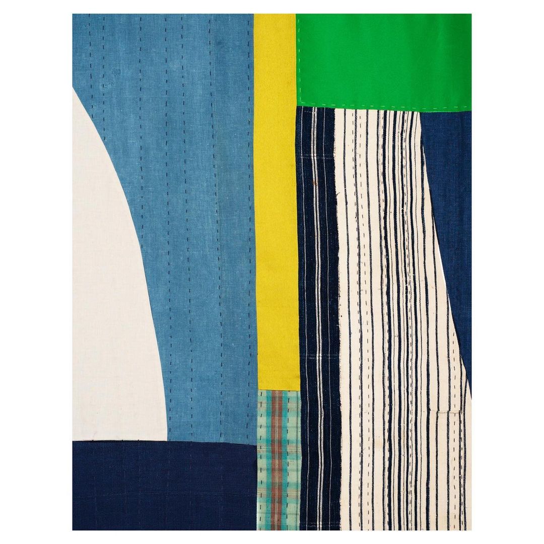 Abstract fabric art with geometric shapes and patterns. Textile design features blocks of color and stitched textures for a unique look.