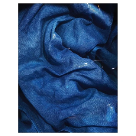 Abstract close-up of a blue fabric, featuring textural folds and subtle light reflections, showcasing textile art or background design.
