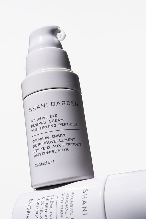 Close-up of two white and grey bottles of Shani Darden Intensive Eye Renewal Cream with Firming Peptides. Beauty, skincare, cosmetic.