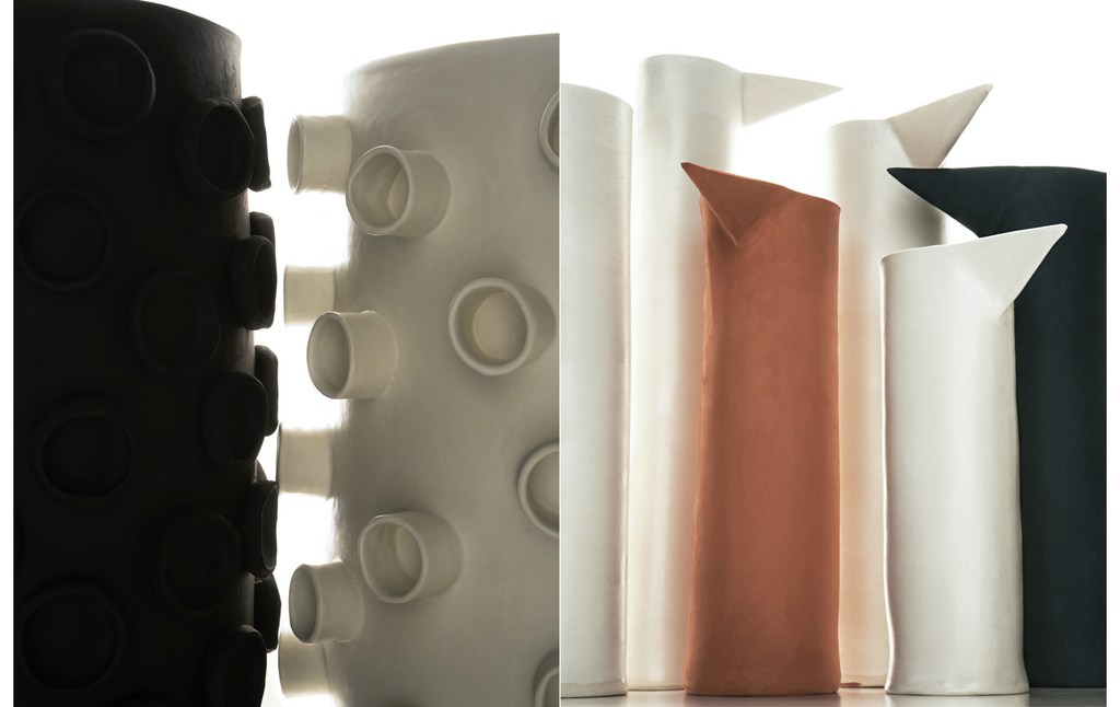 Artistic shot of various ceramic vases and containers in white, black, and rust colors with unique shapes and minimalist designs.