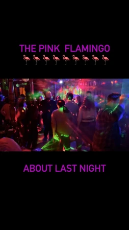 A group of people are dancing in a nightclub with colourful lighting, creating a vibrant and energetic atmosphere.