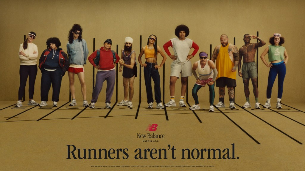 Eleven diverse people in athletic apparel stand on a track in a New Balance advertisement, showcasing a variety of body types and styles.