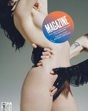 Magazine cover featuring a woman partially obscured by hands and a circular graphic, highlighting fashion and creative industry themes.