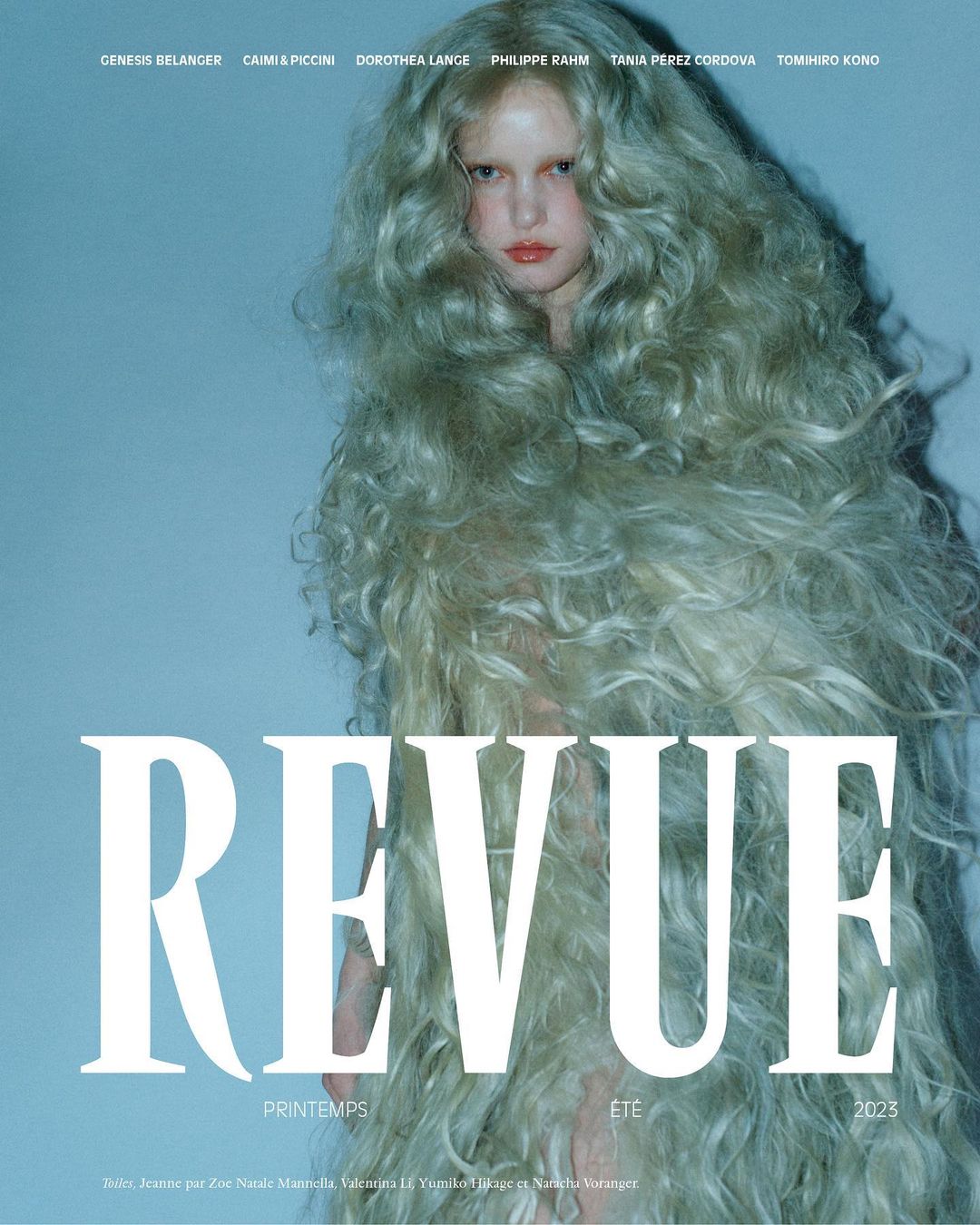 Fashion magazine cover featuring a woman with voluminous, pale blonde hair and neutral makeup against a soft blue backdrop. Revue Spring/Summer 2025.