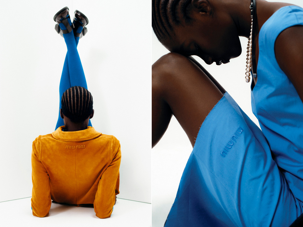 Fashion shot featuring two African women; one in a yellow jacket and blue leggings, the other in a blue dress with a matching necklace. The scene is set indoors.