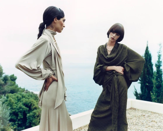 Two female models posing on a terrace overlooking the sea, photographed by Markn.