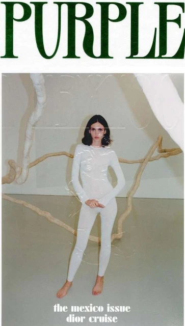 A young woman in a white bodysuit poses in a minimalist setting for a fashion editorial, under 'PURPLE' magazine branding and 'Dior Cruise' text.