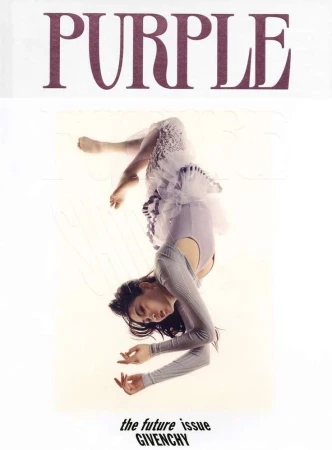 Magazine cover featuring a woman in a light purple dress and grey sweater, upside down against a white background, with bold 'PURPLE' text.