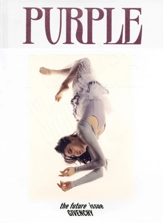 Woman in grey top and white tulle skirt suspended upside down against a white background with purple text at the top