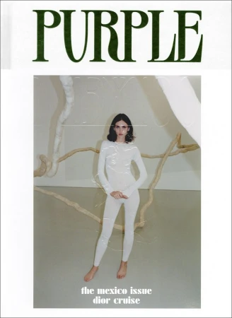 Magazine cover featuring a model in a white bodysuit posing in front of an art installation, with 'PURPLE' in green text above.