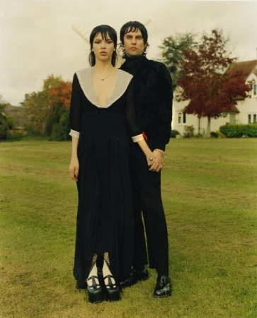 Portrait of a man and a woman standing on grass outdoors, captured by photographer Markn.