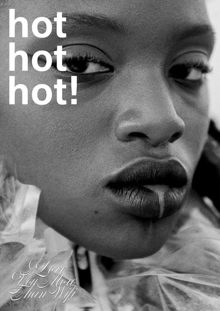 Close-up black and white portrait of an African-American woman with glossy lips, featuring visible text that reads, “hot hot hot!”.
