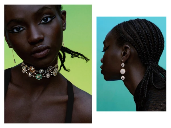 Close-up of a Black woman wearing jewelry: a layered choker necklace and hanging earrings, against a graduated green and blue background.