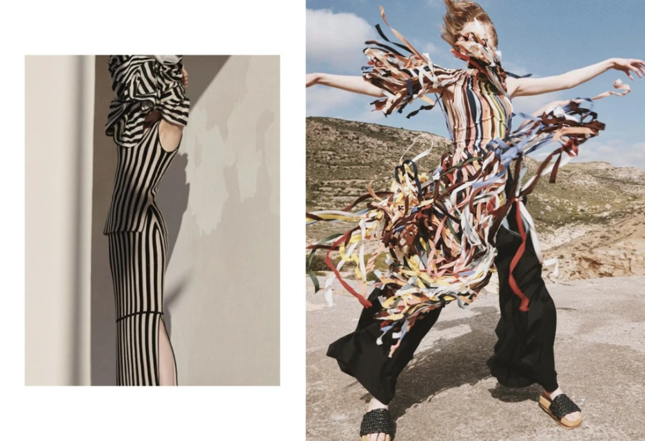 Two fashion models pose in striped dresses against a desert backdrop. The model on the right is styled with colorful ribbons.
