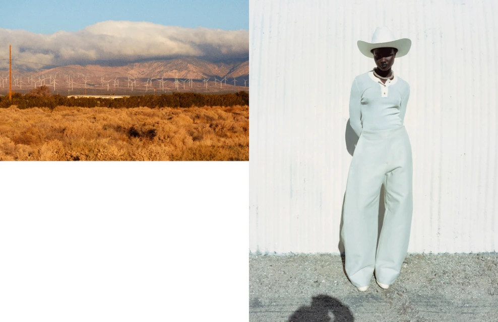 Fashion shot of an African woman in wide-leg pants, long-sleeve top, and cowboy hat against a textured white wall, desert background.