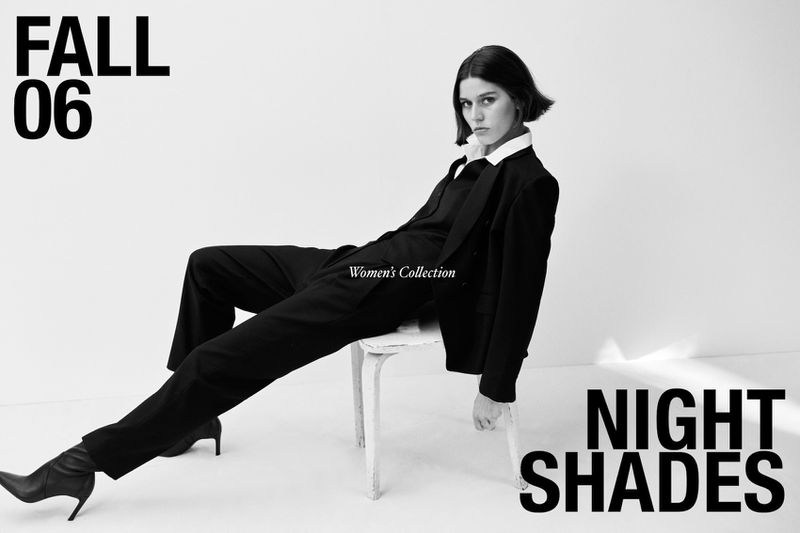 Black and white fashion shot: Woman in a dark suit and boots poses on a white chair against a white background, 'Night Shades' text.
