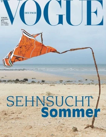 Vogue Deutsch cover featuring a large orange kite, sand, and a beach on a cloudy day. The image evokes the feeling of summer.