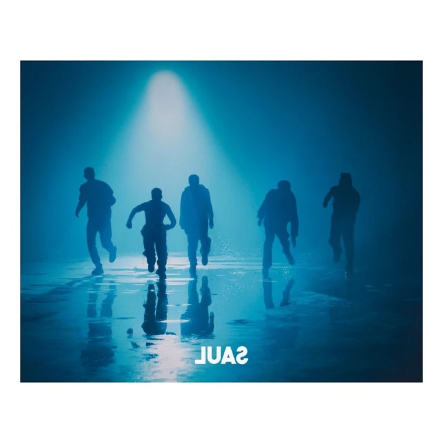 Five figures silhouetted and running against a blue spotlight background with reflections on the wet surface below.