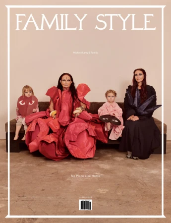Magazine cover featuring Michle Lamy and family styled by Venetia Scott seated on a sofa against a plain background