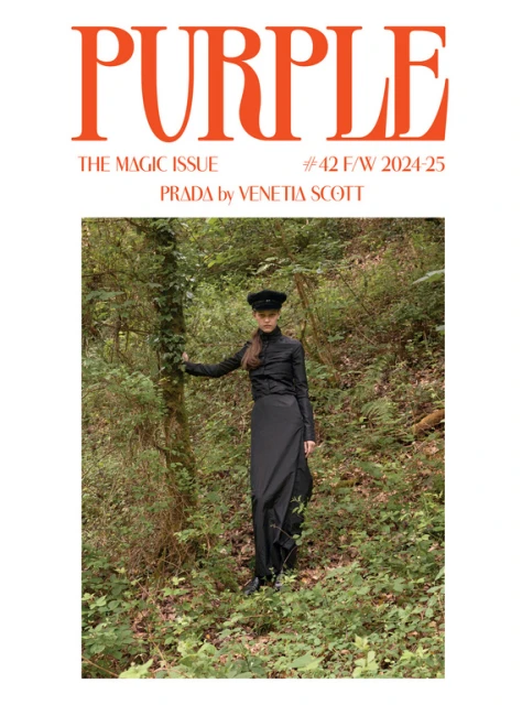 Fashion magazine cover featuring a model in a black dress standing in a forest setting with a bright purple masthead.