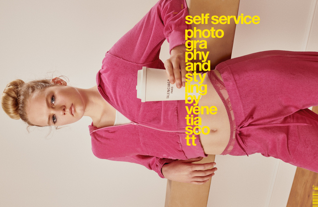Young woman in pink tracksuit poses with Balenciaga-branded coffee cup against a tan background with bold yellow magazine text.