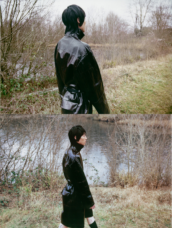 A person in a black, shiny raincoat walks in a grassy field next to a river on a cloudy day, captured in a diptych.
