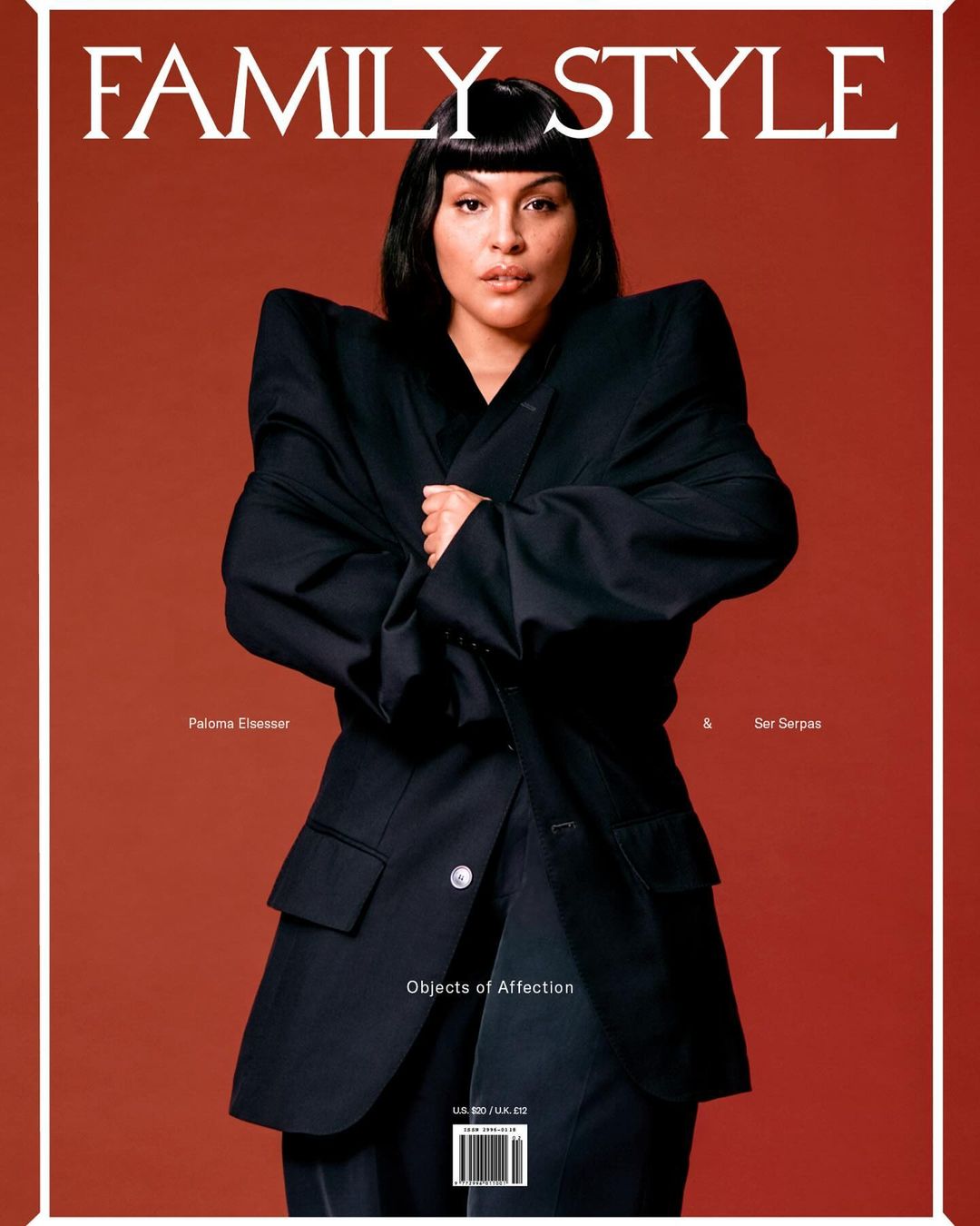 Magazine cover featuring a woman with black hair wearing a black blazer against a red background, promoting 'Family Style'.
