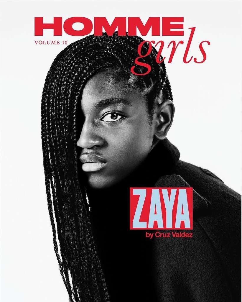 Magazine cover featuring a Black young adult with braided hair, wearing a dark turtleneck, set against a bright, clean backdrop.