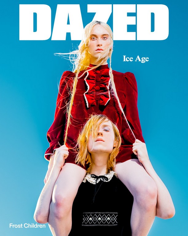 Magazine cover featuring two fair-skinned adults, one on the shoulders of the other, against a clear blue sky backdrop, and magazine text.