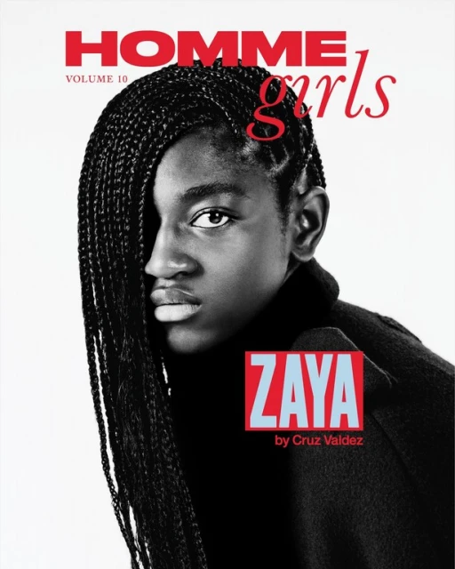 Magazine cover featuring a portrait of Zaya Wade, styled with braids, wearing a black top, with red and blue text on a white background.