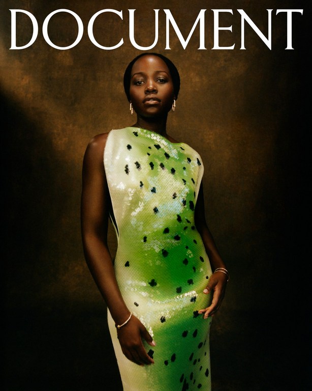 Magazine cover featuring Lupita Nyong'o in a green dress with black polka dots, posing against a brown background.
