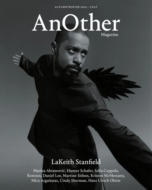 Magazine cover featuring LaKeith Stanfield wearing a black garment with wing-like attachments, set against a blurred grey background.