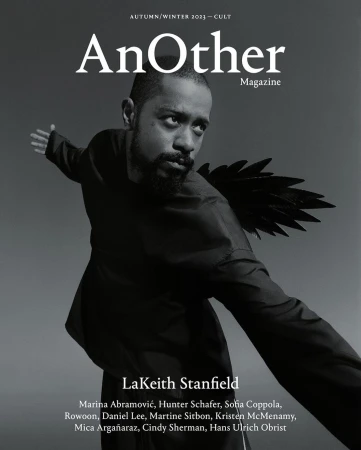 Magazine cover featuring LaKeith Stanfield wearing a black garment with wing-like attachments, set against a blurred grey background.