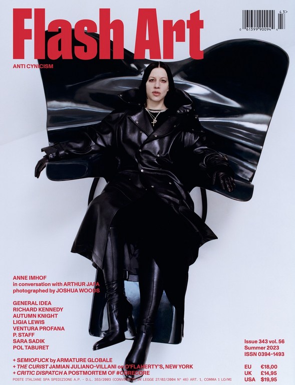 Flash Art magazine cover featuring a pale, dark-haired person in a black coat sitting on a black sculptural chair against a pale background.