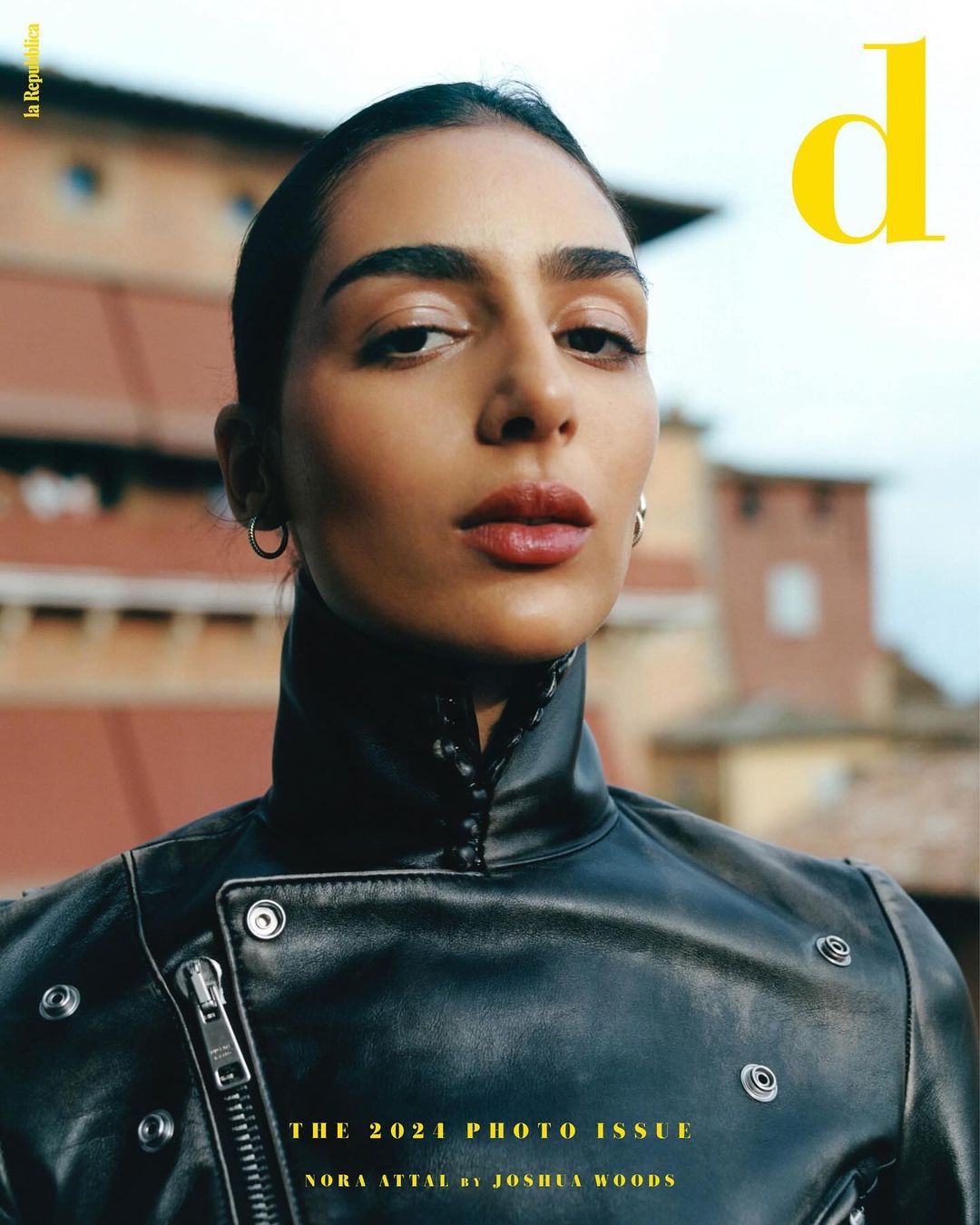 Magazine cover featuring a portrait of Nora Attal wearing a black leather jacket, with a backdrop of an outdoor building.