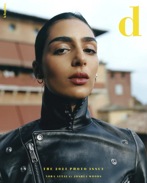 Magazine cover featuring a stylish woman in a black leather jacket, posing outdoors with neutral expression and background architecture.