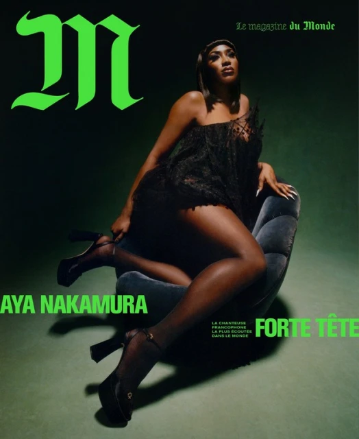 Magazine cover featuring Aya Nakamura in a short black dress, seated on a blue chair against a dark green background with bright green typography.