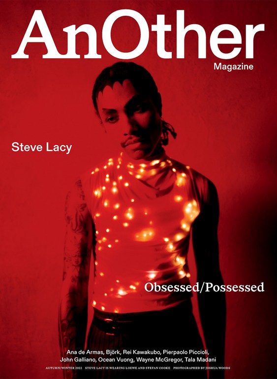 Magazine cover featuring Steve Lacy in a red color scheme, wearing a top adorned with glowing lights, with the title 'AnOther Magazine'.