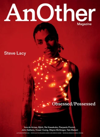 Magazine cover featuring Steve Lacy in a red color scheme, wearing a top adorned with glowing lights, with the title 'AnOther Magazine'.