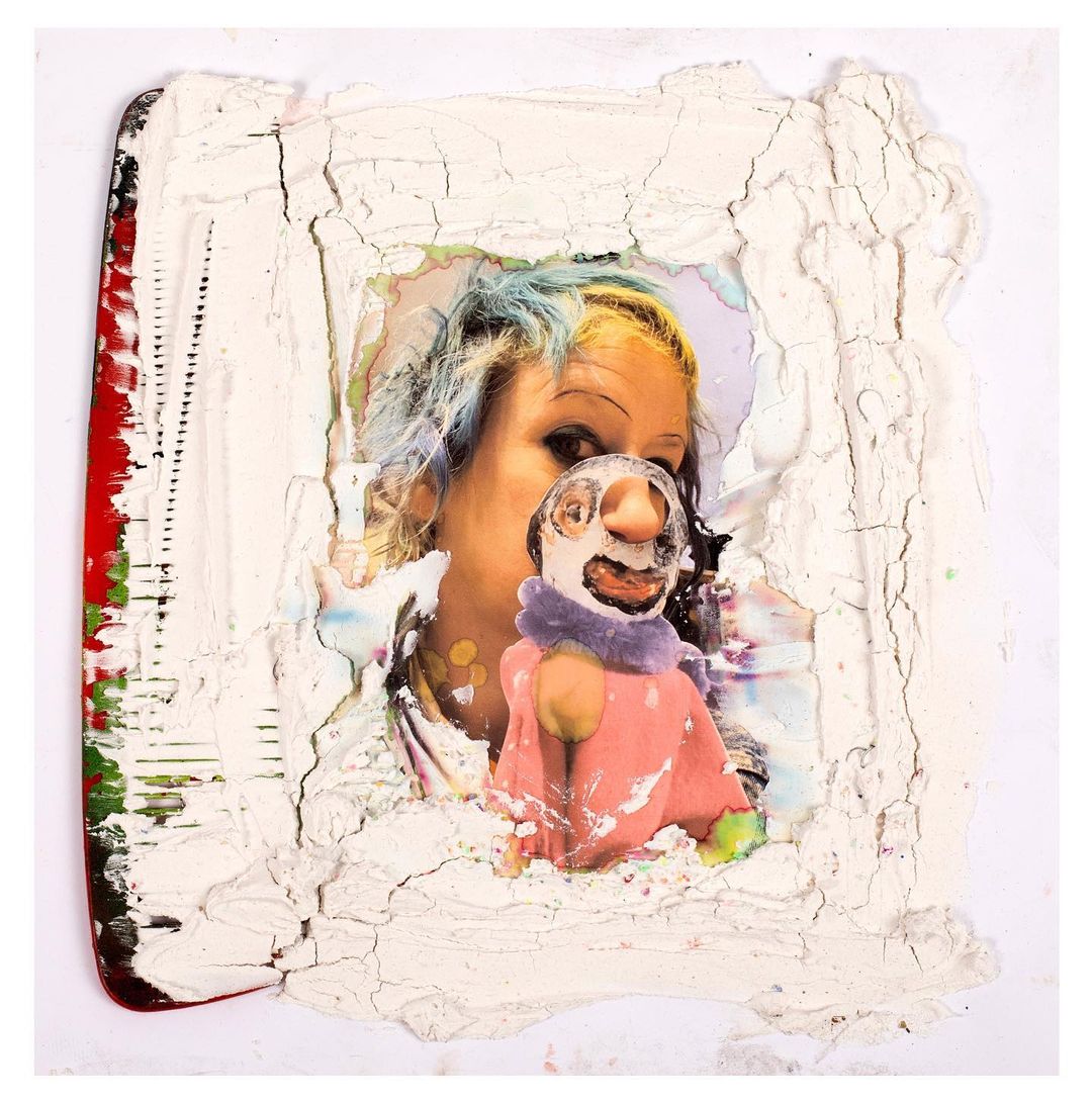 Abstract art featuring a woman with dyed hair, overlaid with textured white material and a playful paper cutout of a figure.