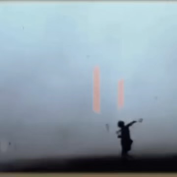 Silhouette of a child with arms outstretched against a pale sky, with abstract geometric forms in the background, creating an eerie scene.