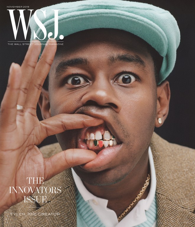 Close-up cover of WSJ magazine featuring Tyler, the Creator wearing a light blue cap, brown jacket, and gold teeth with red and green designs.