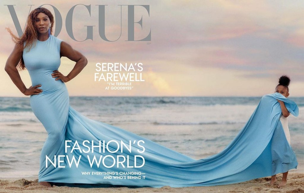 Vogue cover featuring Serena Williams in blue dress on beach with child, fashion editorial, ocean backdrop and magazine text overlay.