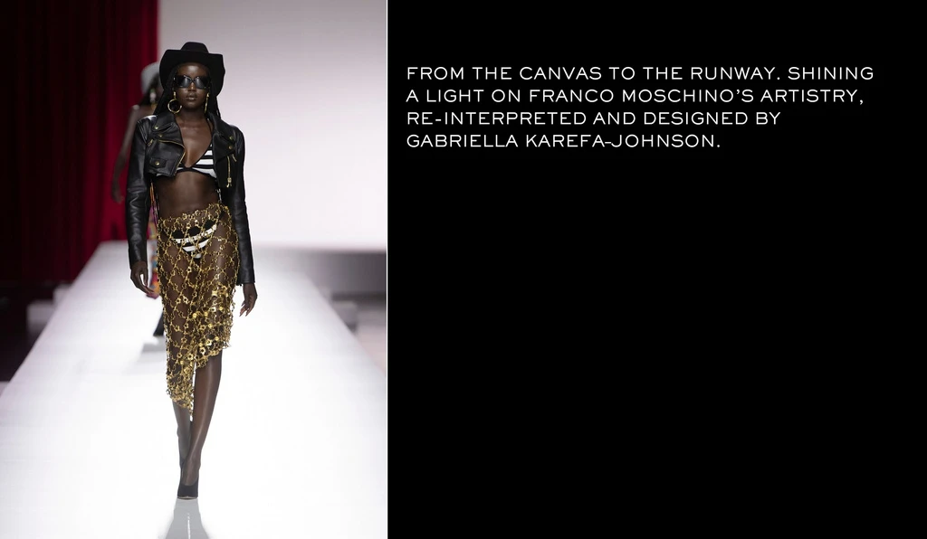 Runway fashion show features Black model in hat, leather jacket, gold chain skirt, and striped bikini top, walking towards the camera.