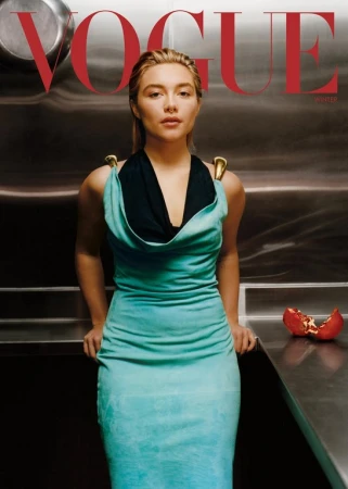 Florence Pugh in a teal dress with black halter top styled by Gabriella Karefa-Johnson against a metal wall