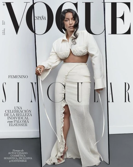 Vogue España cover featuring a single female adult model in an off-white dress with a slit, posing in a studio with bright, even lighting.